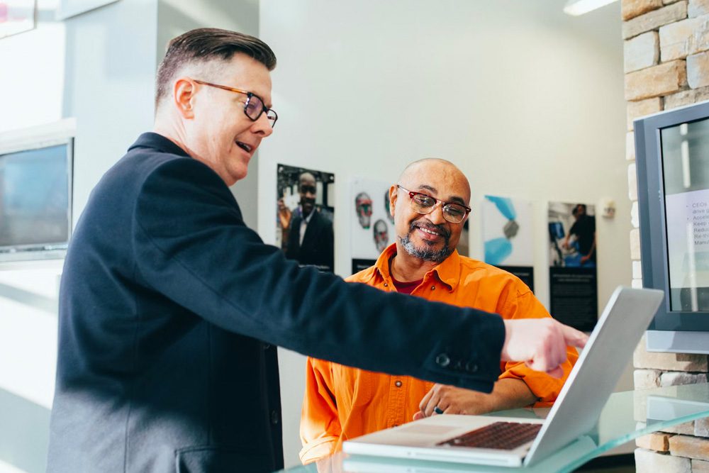 Happy business man checking out a website