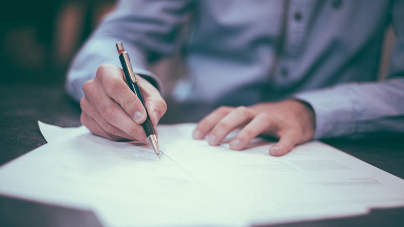 a man signing a contract