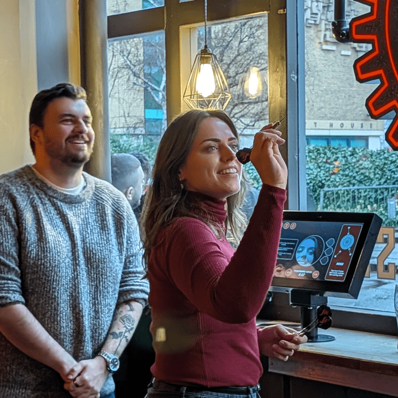 SourceCodeStudio Team member Kat playing darts